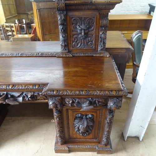 2068 - A Victorian carved oak pedestal sideboard, with raised mirrored back, allover carved decoration, 3 f... 