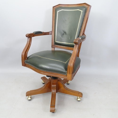 2070 - A green studded leather upholstered swivel desk chair