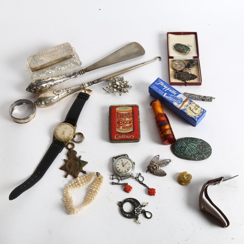 1056 - A silver-handled button hook and shoe horn, silver brooch, napkin ring and a silver-topped dressing ... 