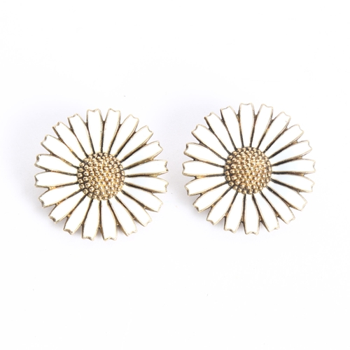 1074 - ANTON MICHELSEN - a pair of silver and white enamel daisy pattern clip-on earrings