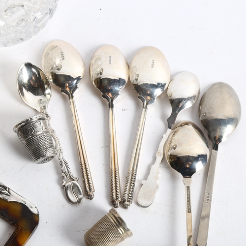 1095 - A group of silver and plated items, to include 7 silver thimbles, an embossed silver-topped dressing... 