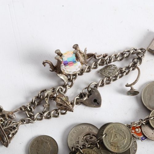 1099 - A Continental coin bracelet, a silver charm bracelet, and silver-handled button hook