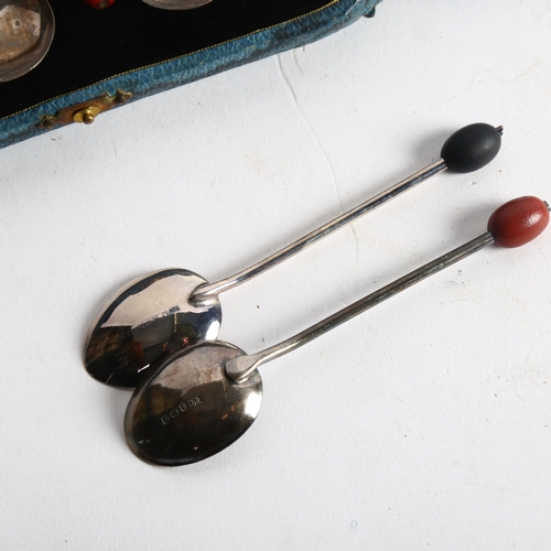 1104 - A cased set of 6 silver bean-end coffee spoons, Birmingham 1931, and a similar silver plated set of ... 