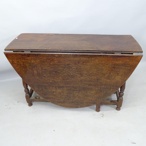 2212 - An Antique oak oval gateleg dining table, 120cm x 74cm x 46cm