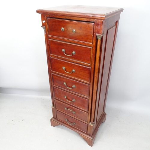 2220 - A reproduction mahogany chest of 7 drawers, with 2 turned pilasters, brass mounts, on bracket feet, ... 