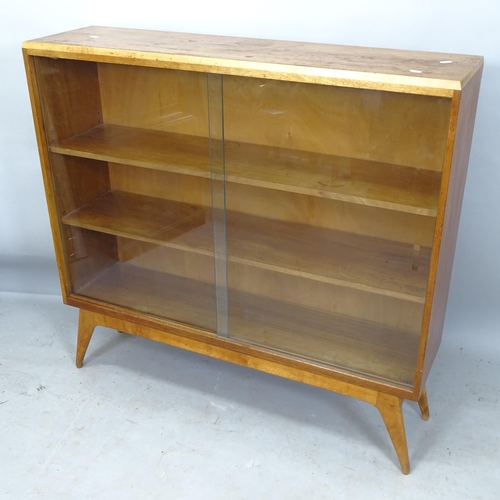 2223 - A mid-century teak bookcase, with 2 adjustable shelves and glass sliding doors, 107cm x 101cm x 28cm