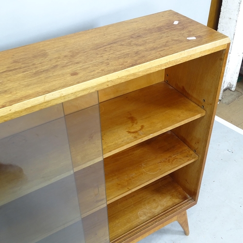 2223 - A mid-century teak bookcase, with 2 adjustable shelves and glass sliding doors, 107cm x 101cm x 28cm