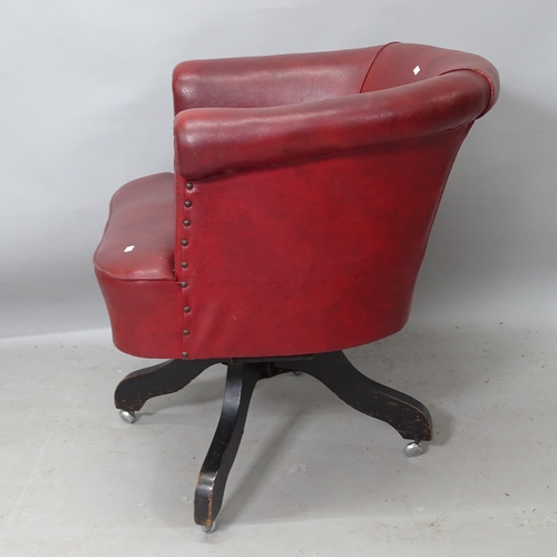 2234 - An early 20th century red leather upholstered swivel desk chair