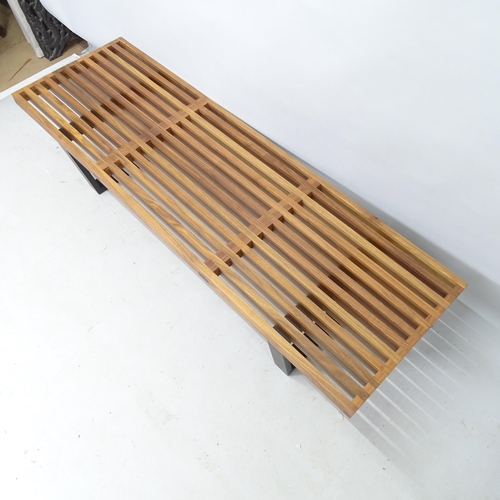 2243 - A mid-century design slatted walnut bench, in the manner of George Nelson