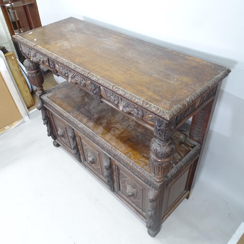 2261 - An Antique oak 2-tier buffet, with 3 fitted drawers and 3 cupboards under, and allover carved decora... 