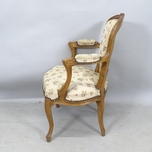 2273 - A French oak and upholstered open armchair