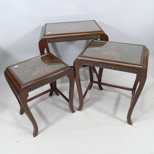 2275 - A Chinese hardwood nest of 3 occasional tables, with relief carved decoration, widest 57cm