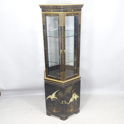 2287 - An Oriental 3-section black lacquered hexagonal display cabinet, with gilded decoration, 4 doors, an... 