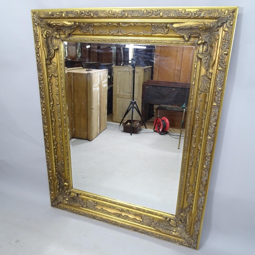 2308 - A contemporary gilt-framed bevel-edge wall mirror, 130cm x 160cm