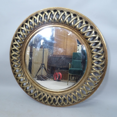 2309 - A large circular resin-framed bevel-edge wall mirror, 115cm