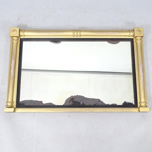 2313 - A Regency gilt oval mantel mirror, with ebonised mounts and split turned columns, 90cm x 57cm