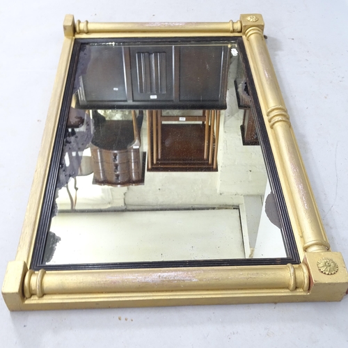 2313 - A Regency gilt oval mantel mirror, with ebonised mounts and split turned columns, 90cm x 57cm