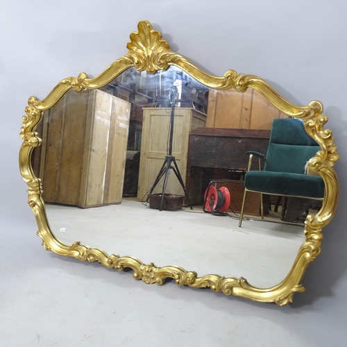 2315 - A modern gilt painted wall mirror of shaped form, 118cm x 90cm