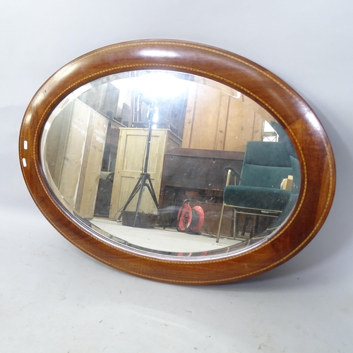 2317 - An Edwardian mahogany and satinwood inlaid oval mirror, 93cm x 63cm