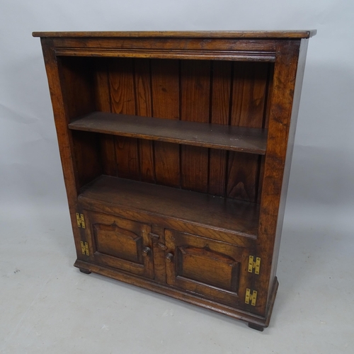 2324 - A stained oak open bookcase, with single adjustable shelf and cupboards under, 84cm x 97cm x 27cm