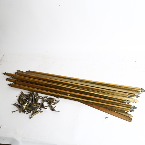 710 - A set of 14 solid brass stair rods, length 66cm, with clips