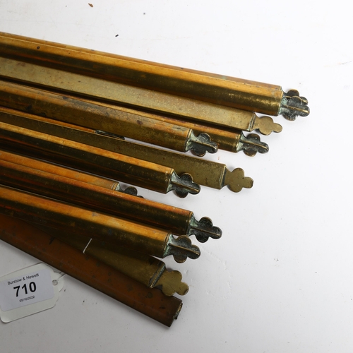 710 - A set of 14 solid brass stair rods, length 66cm, with clips