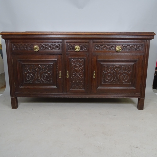 2612 - A 1930s carved oak sideboard, having raised back,  3 fitted drawers and cupboards under, on stile le... 