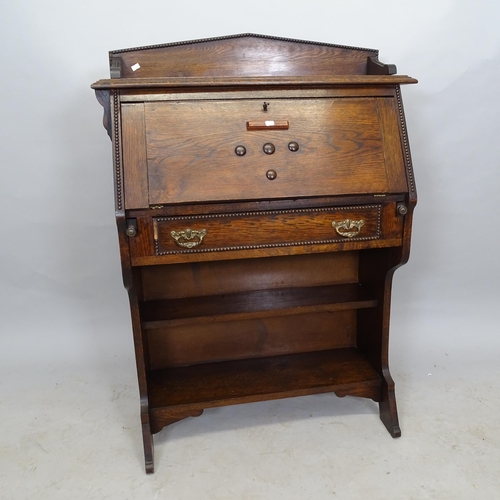 2631 - 1930s oak student's bureau, the fall-front revealing a fitted interior, with single frieze drawer an... 