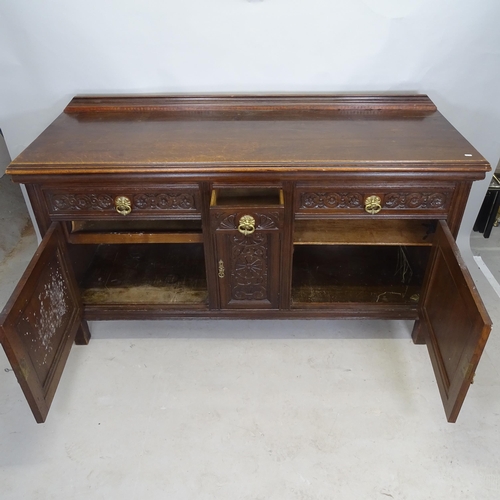 2612 - A 1930s carved oak sideboard, having raised back,  3 fitted drawers and cupboards under, on stile le... 