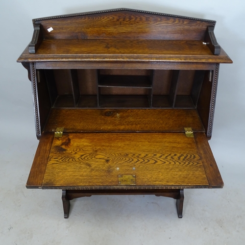 2631 - 1930s oak student's bureau, the fall-front revealing a fitted interior, with single frieze drawer an... 