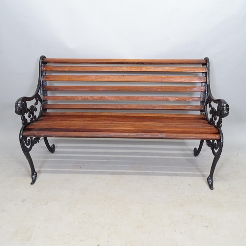 2662 - A stained teak slatted garden bench, with cast-iron ends, L123cm