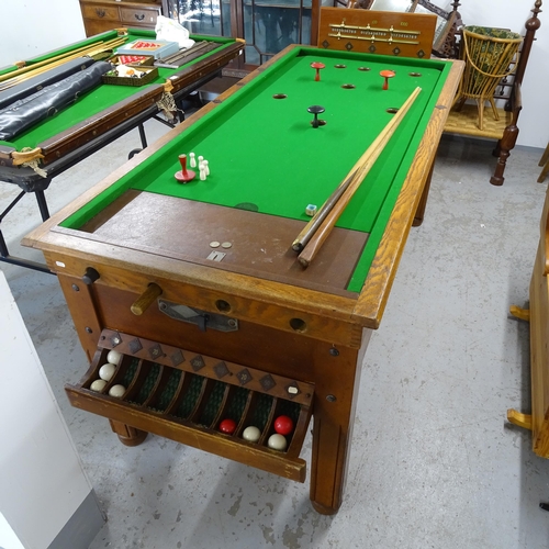 2663 - An early 20th century bar billiards table, with cues, balls and scoreboard, operated on a sixpence, ... 