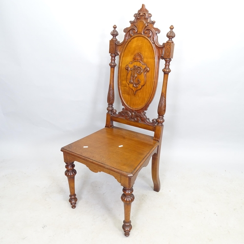 2664 - A 19th century mahogany hall chair, with applied carved decoration