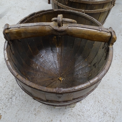 2738 - A pair of Chinese elm and steel-bound dome-bottom buckets on stands, W50cm, H55cm