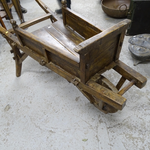 2739 - A Chinese elm wheelbarrow, height 70cm, length 170cm