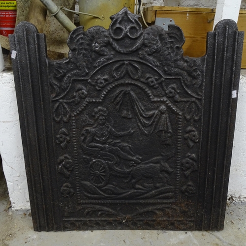 2758 - A 19th century cast-iron fire-back with embossed decoration, and an Arts and Crafts copper-clad fend... 