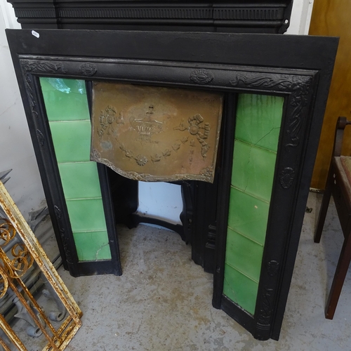 2778 - An Antique cast-iron fire surround, with tiled panels and brass hood, 91cm x 97cm