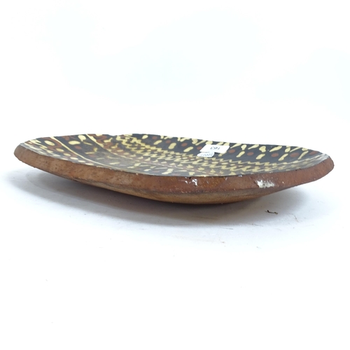 163 - An earthenware pottery slipware shallow dish, length 37cm
