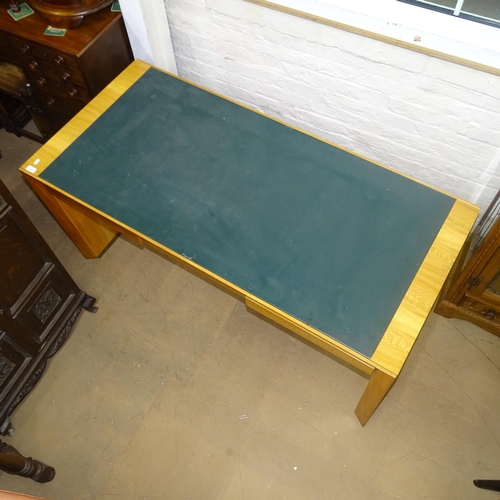 2015 - A contemporary teak kneehole writing desk, with label for Rolex, having inlaid green leather skiver ... 