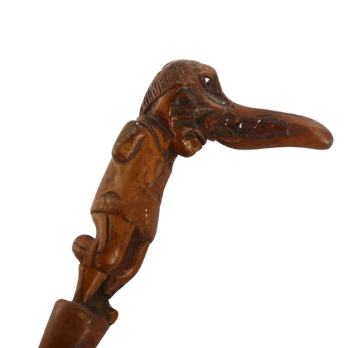 1007 - A 19th century novelty walking stick, the handle carved in the form of a one-legged man with a big n... 