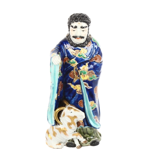 1009 - A Japanese porcelain figure with a goat, gilded blue glaze robes, height 30cm