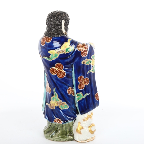 1009 - A Japanese porcelain figure with a goat, gilded blue glaze robes, height 30cm