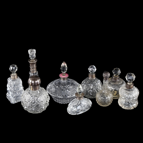 1035 - A group of 9 silver-mounted perfume bottles, including 1 with a pink enamel collar, tallest 17cm (9)