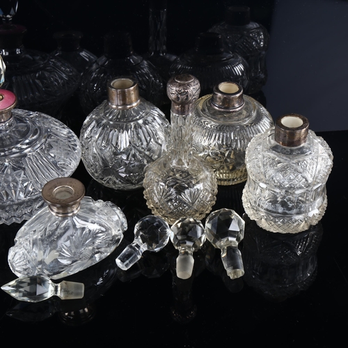 1035 - A group of 9 silver-mounted perfume bottles, including 1 with a pink enamel collar, tallest 17cm (9)