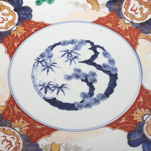 1049 - A large Japanese 19th century porcelain charger with painted and gilded decoration, 4 character mark... 