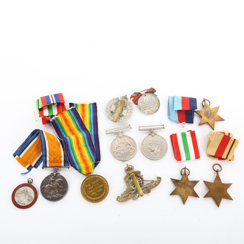 1055 - A collection of Great War and Second World War General Service medals, cap badges and medallions, Fi... 