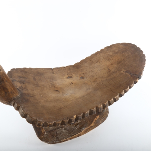 1061 - An African Tribal stool in the form of a bird, carved from a single piece of wood, length 62cm