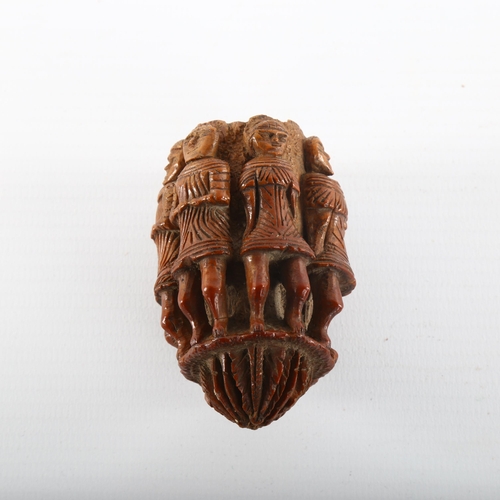 1092 - An 19th century nut flask with relief carved figures all round, length 6.5cm