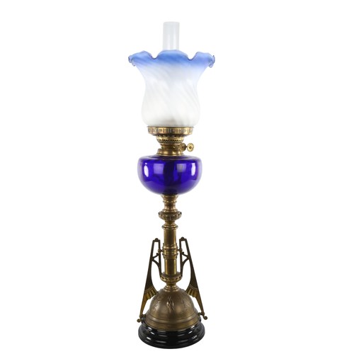 1010 - Victorian brass and blue glass duplex oil lamp, in the manner of Christopher Dresser, with embossed ... 