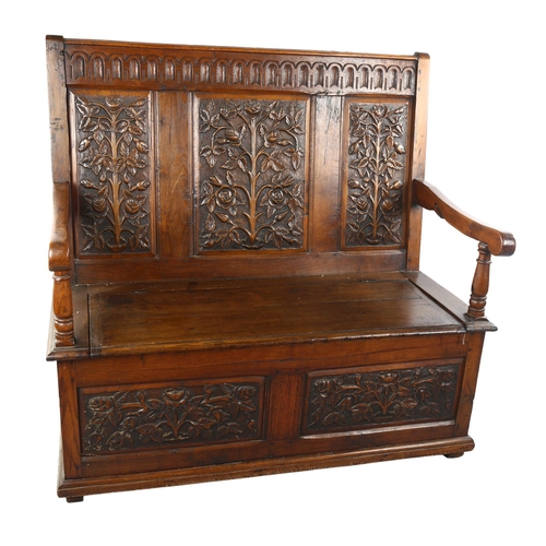 1069 - An Antique oak settle with relief carved rose design 3-panel back, rising seat and carved 2-panel fr... 